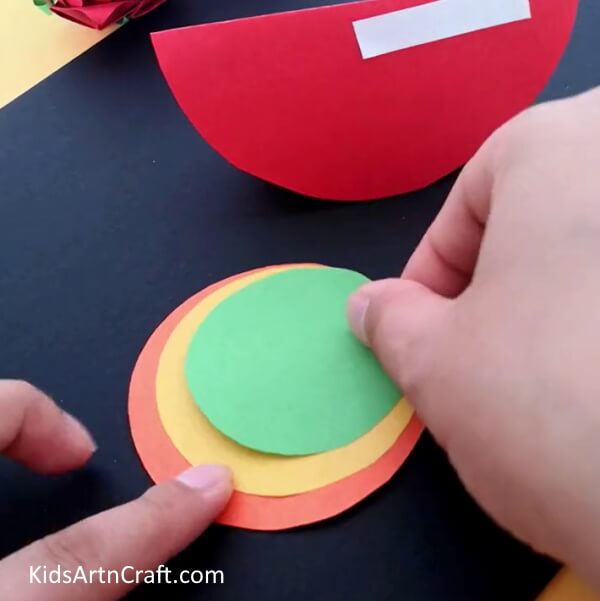 Adding Green Oval - Assemble a paper snail craft with various colors for children.