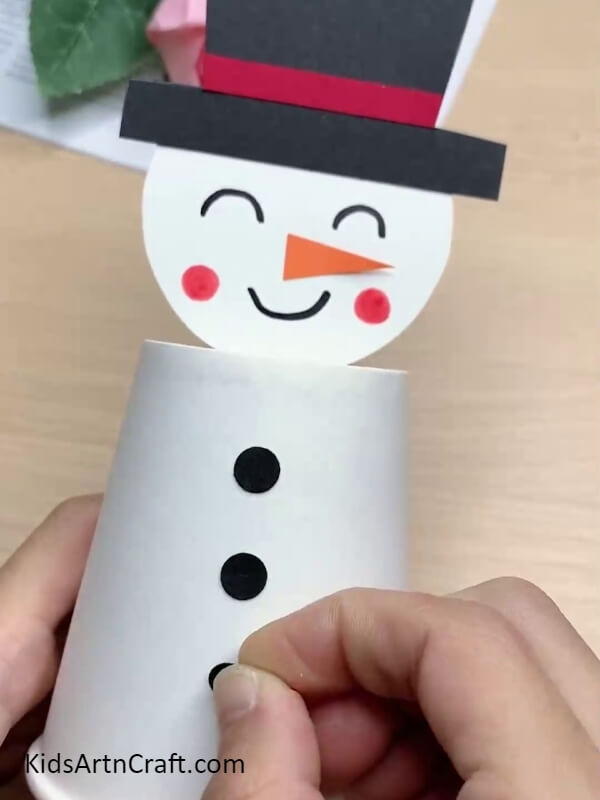 The Snowman's Buttons- A paper cup craft tutorial for kids to make their own snowman.