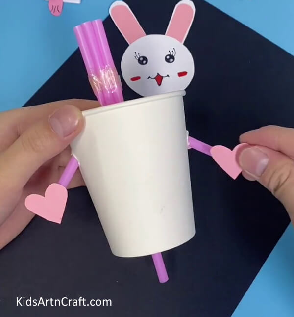 Pasting Hearts On The Hands-Put Together a Bunny Toy with Straws and Paper Cups For Youngsters