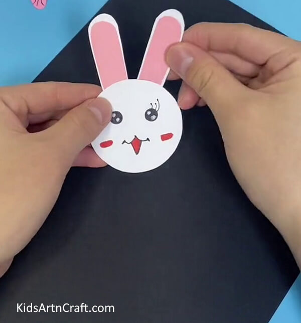 Sticking The Ears To The Face-Assemble a Bunny Toy with Straws and Paper Cups For Children 