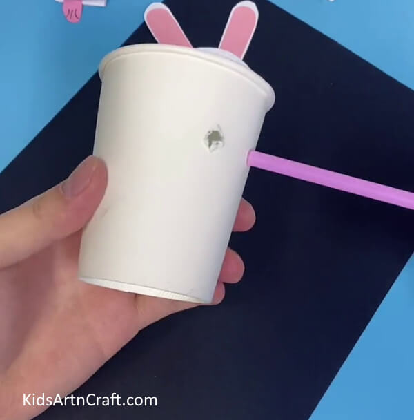 Making Holes At The Sides Of The Paper Cup-Fabricate a Bunny Toy with Straws and Paper Cups For Kids