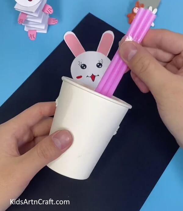 Inserting The Joint Straws In The Cup- Build a Bunny Toy with Straws and Paper Cups For Kids