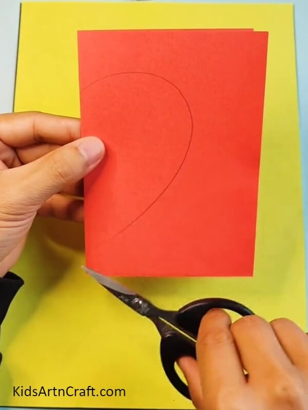 Drawing Heart On Red Color Craft Paper Using A Pencil-steps For Novices On How To Make A Strawberry Craft By Yourself