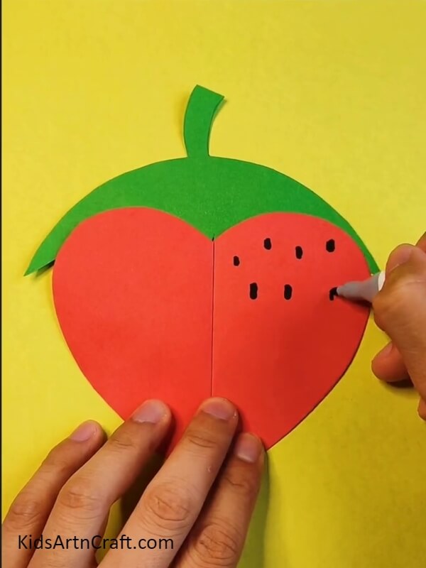 Putting Dots On The Strawberry Using A Black Pen- Tutorial For Newcomers On How To Do A Strawberry Craft By Themselves