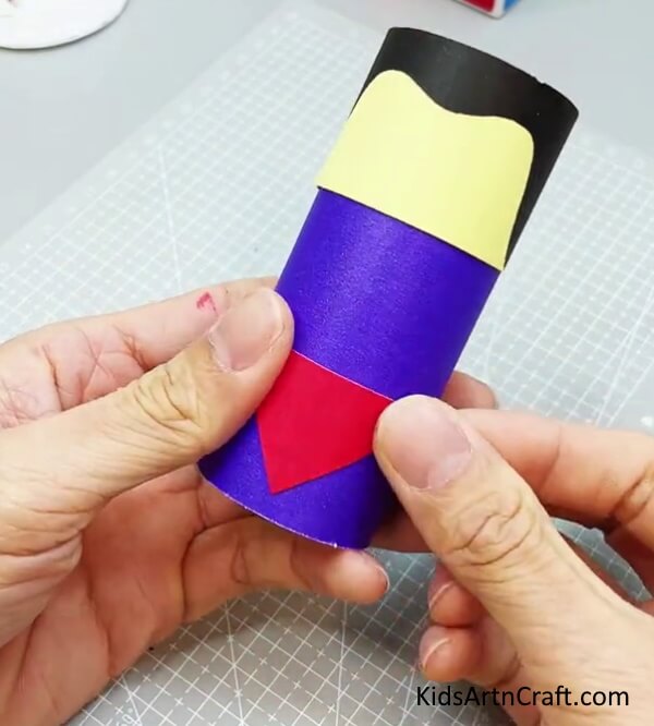 Pasting A Red Triangle For Its Dress - Building a Superman Keepsake Using a Cardboard Tube
