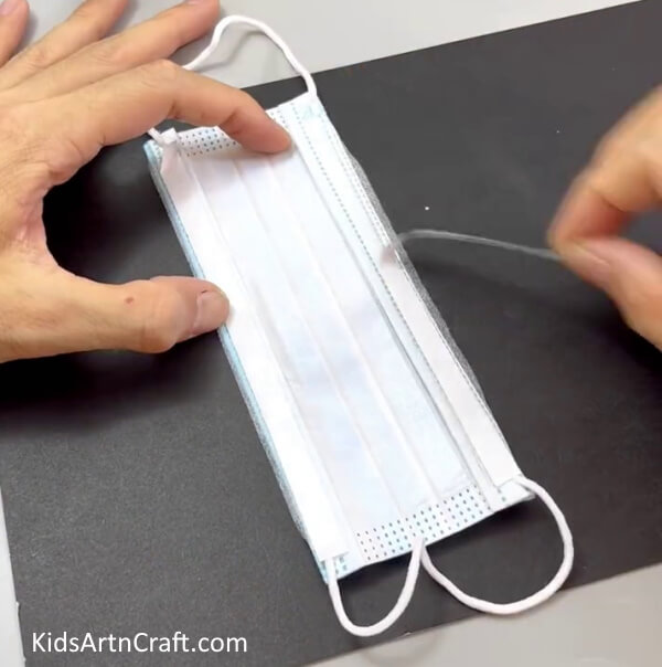 Sticking Double-Sided Tape On The Folded Corners - Learn how to craft a surgical mask pouch with this simple tutorial.