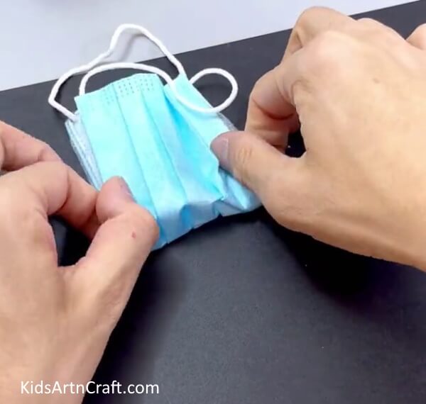 Folding The Mask Vertically - This tutorial will show you how to create a surgical mask pouch with ease.