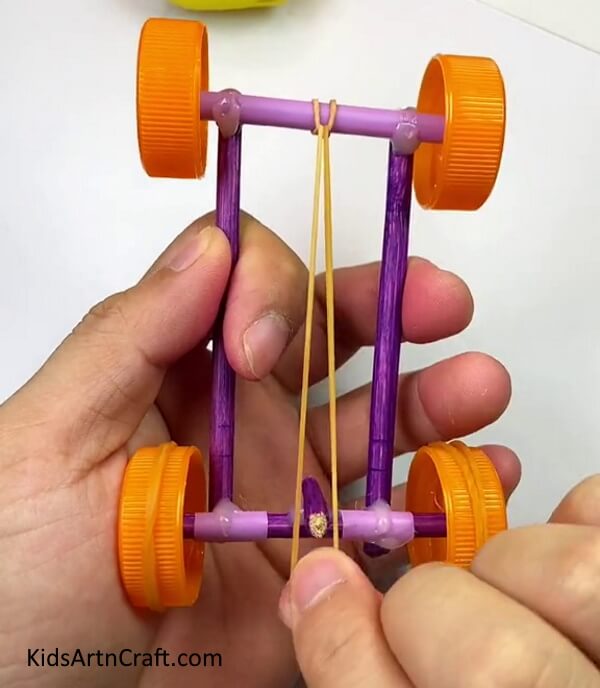Stretching The Rubber Band Inside The Smallest Stick- Constructing a toy vehicle from chopsticks, rubber bands, straws and bottle lids. 