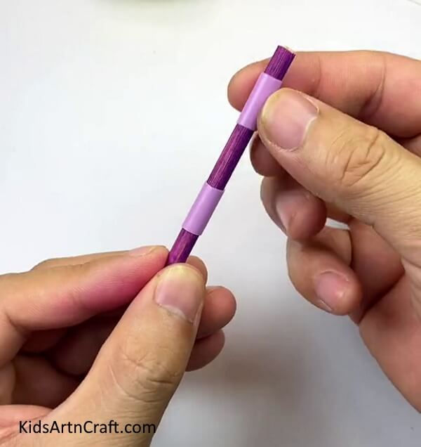 Inserting The Small Straw Pieces Into Stick- Putting together a toy car using chopsticks, rubber bands, straws, and bottle caps. 
