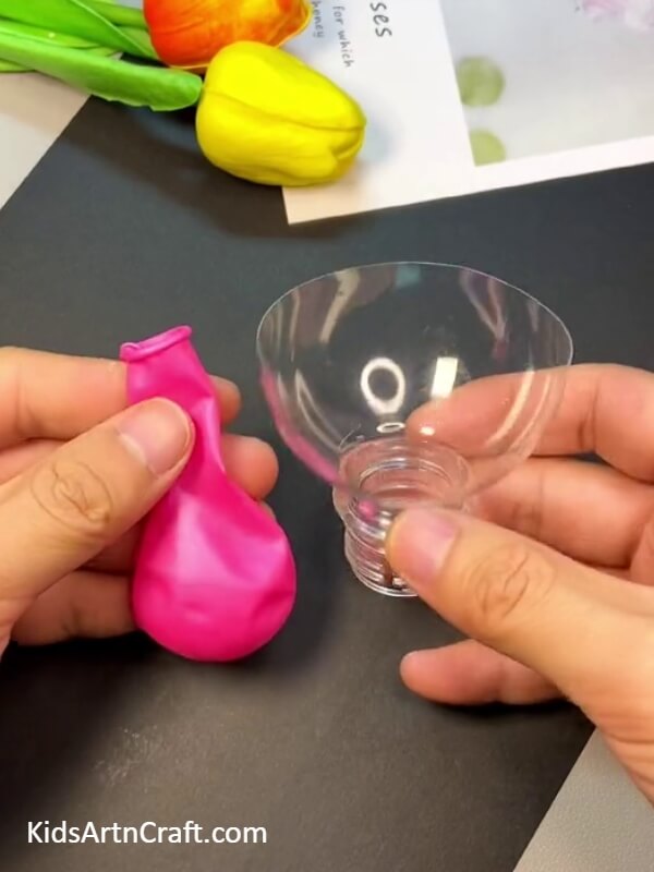 Working on the plastic water bottle- Step-by-Step Guide to Doing Balloon Facial Art with Children