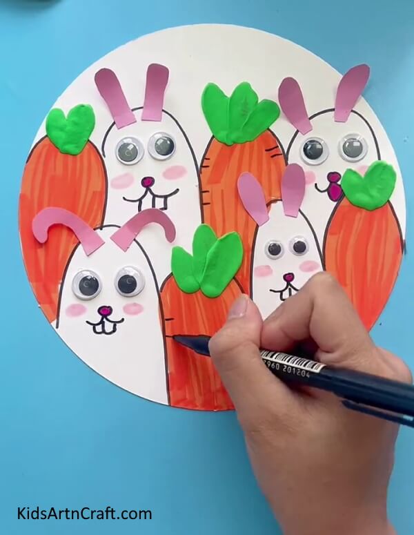 Give Effect To The Carrot With a Black Sketch Pen-. An easy drawing of a bunny and carrot for young ones.