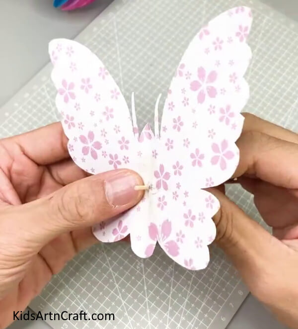 Inserting A Stick - Kids Can Construct a Butterfly Paper Craft At Home