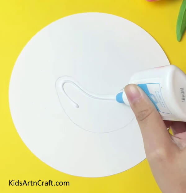 Appling Glue to Stick Tried Grass- A Tutorial for Crafting a Chicken with Simple Steps for Kids 