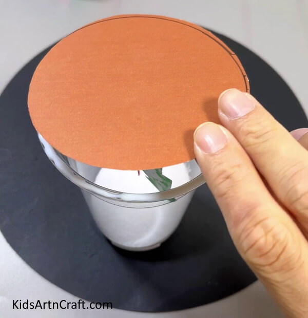 Pasting The Circle Over The Glass - Simple projects for children to construct during the holiday season