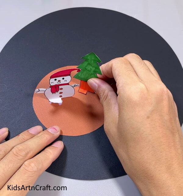 Pasting Christmas Tree On Circle - Simple Christmas crafts for youngsters to construct at home