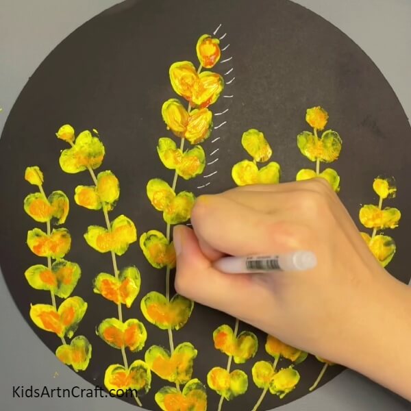 Draw small lines around the flowers- Create Flower and Ladybug Designs with a Few Simple Steps and the Tips of Your Fingers