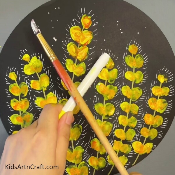 Give the sprinkle effect using the paintbrush- Artistic Forms of Flower Art & Ladybug Crafts at the Tip of Your Fingers - Step-by-Step Tutorial