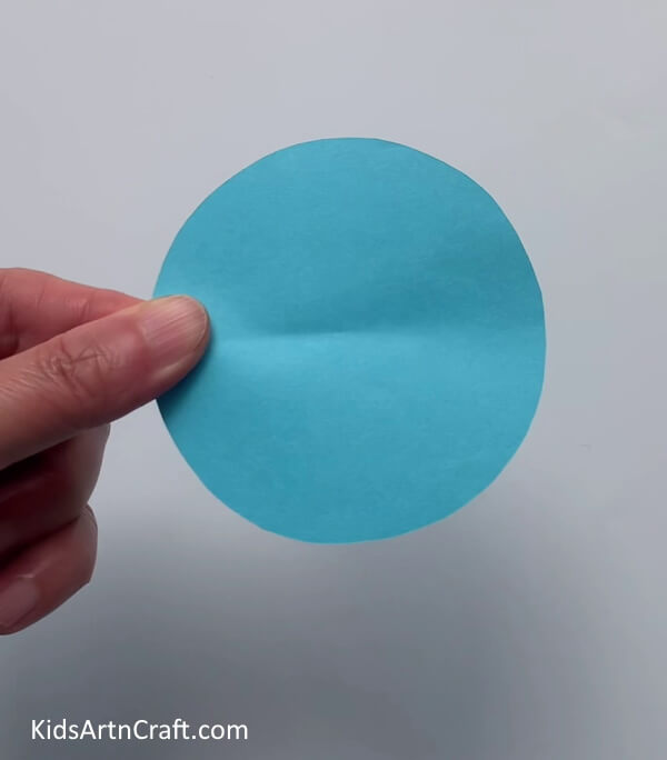 Cutting A Blue Circle- Crafting paper to construct flowers with ease for children