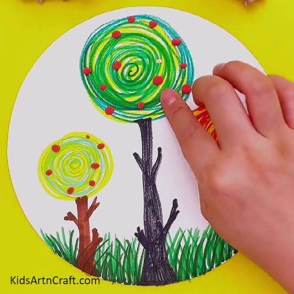 Sticking small clays on each tree- An effortless guide for kids to understand Kandinsky's circle tree scenery painting 