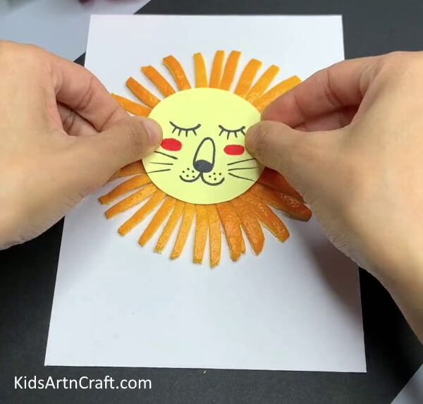 Pasting The Lion Face- An orange peel can be used to create a lion in a simple way for kids. 
