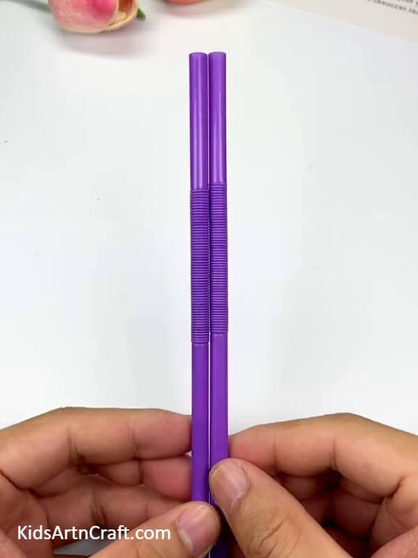 Take two foldable straws- Step-by-step guide for children on how to make a hanging man craft using straws.