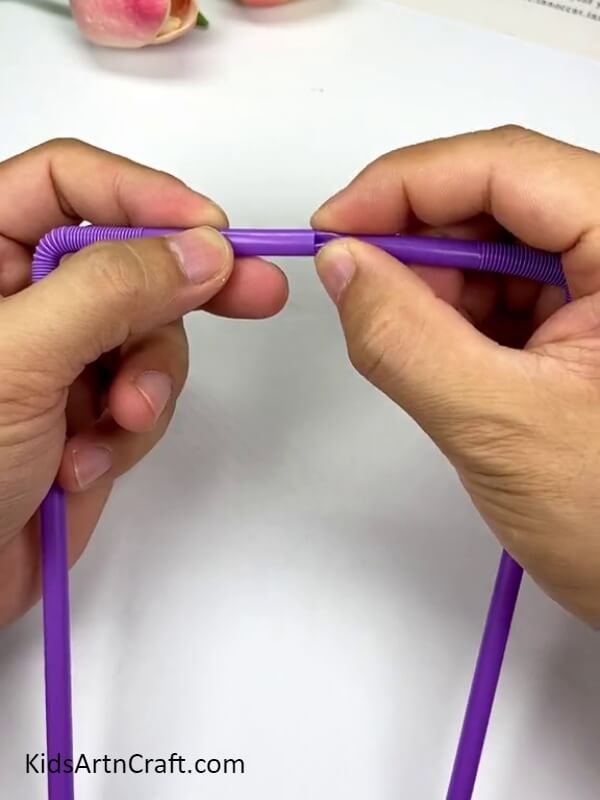 Insert one of the straw into other straw- Detailed instructions for making a person-shaped hanging decoration with straws for kids.