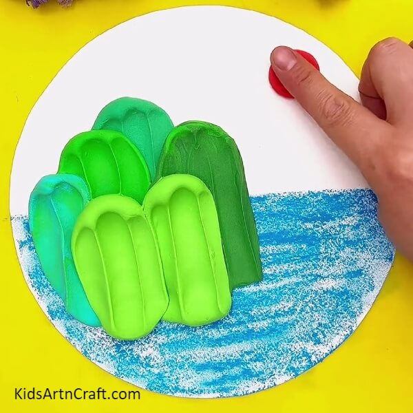 Making the sun with red modelling clay- Easy Art and Craft Projects for Kids Focused on Mountain and Ocean Views 