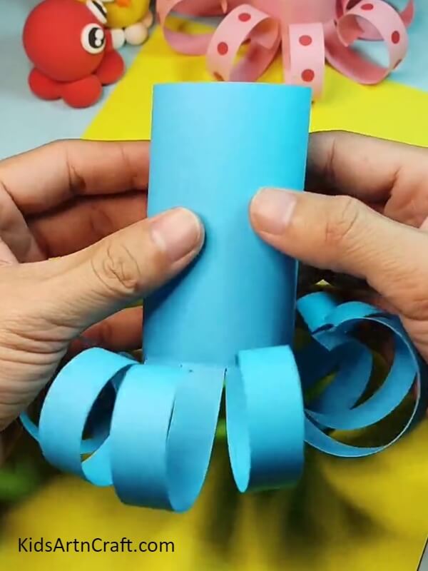 Folding the sheet at the top- Simple tutorial for making a paper octopus with kids. 