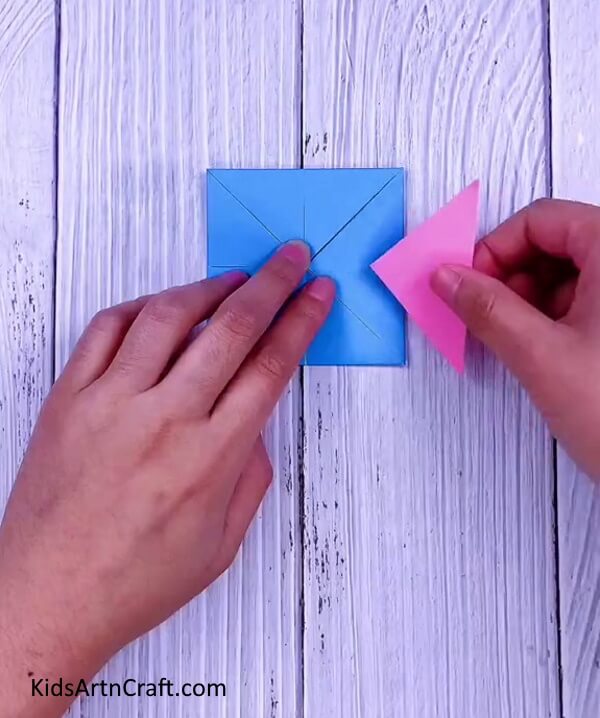 Similarly, fold all the other edges too- Making origami Paper Paku Paku is easy with this guide for children.