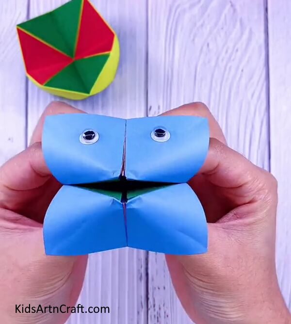 Place you fingers in the pockets given below- A detailed tutorial on making origami Paper Paku Paku for kids.