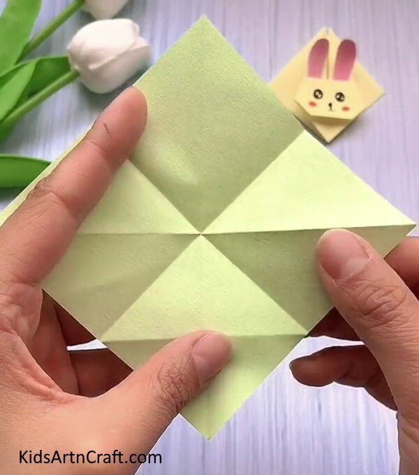 Folding And Making Creases- A straightforward guide to making a Rabbit Face with Origami for children.