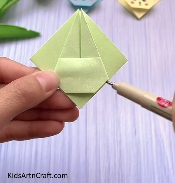 Taking A Black Pen- Here is a guide to creating a bunny face with origami, perfect for kids. 