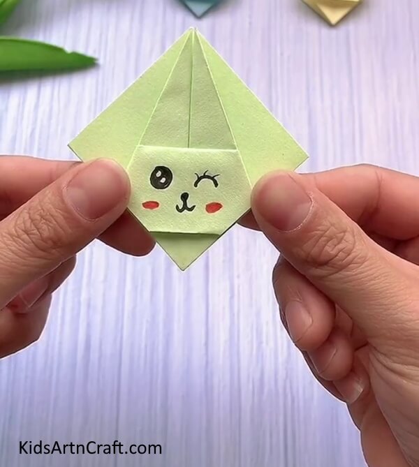 Drawing The Face Details-A fun and easy origami rabbit face craft tutorial specifically designed for kids. 
