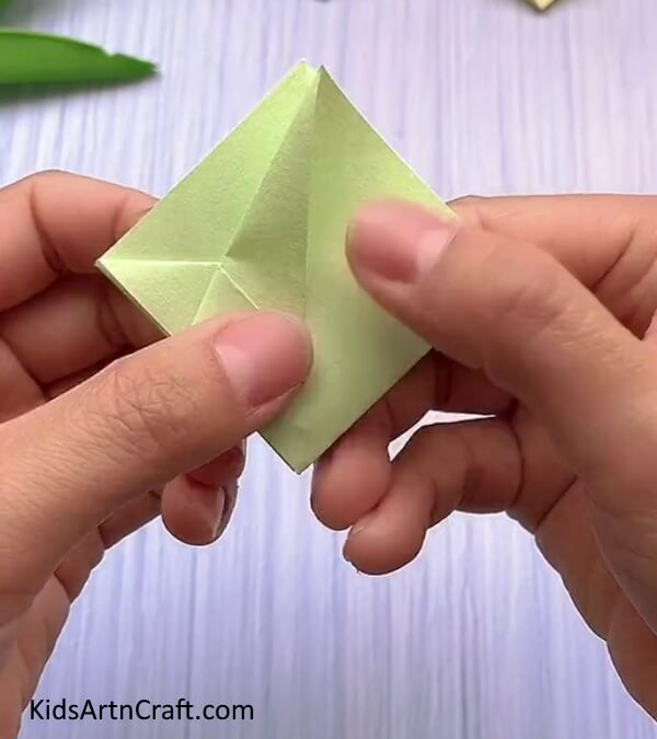 Folding The Corner To The Crease-A basic Origami Rabbit Face design for kids.