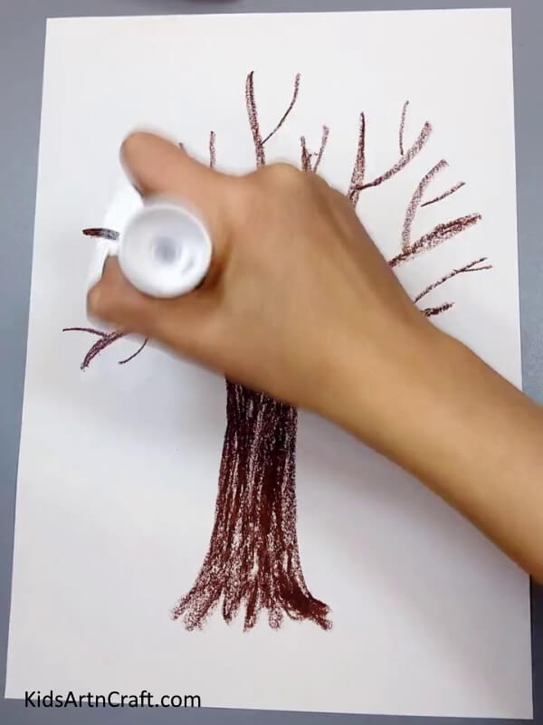 Applying Glue - An uncomplicated paper craft tree that includes a bird nest made specifically for children. 