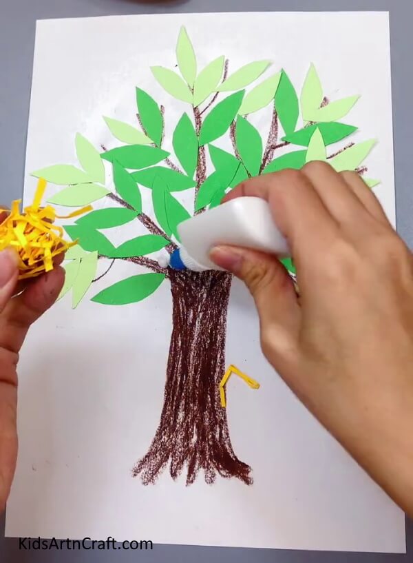 Applying Glue - A simple paper tree with a bird's nest for kids to enjoy. 