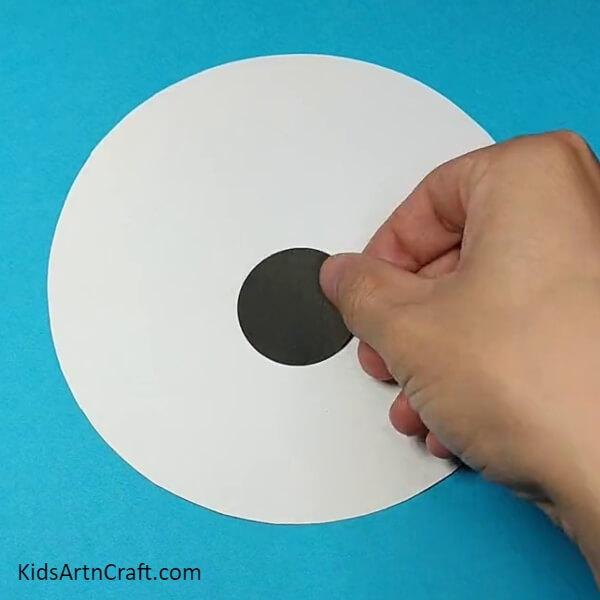 Cut out a circle from Black craft paper for the nose- Crafting a Dog Face Out of Paper - an Easy Tutorial for Kids