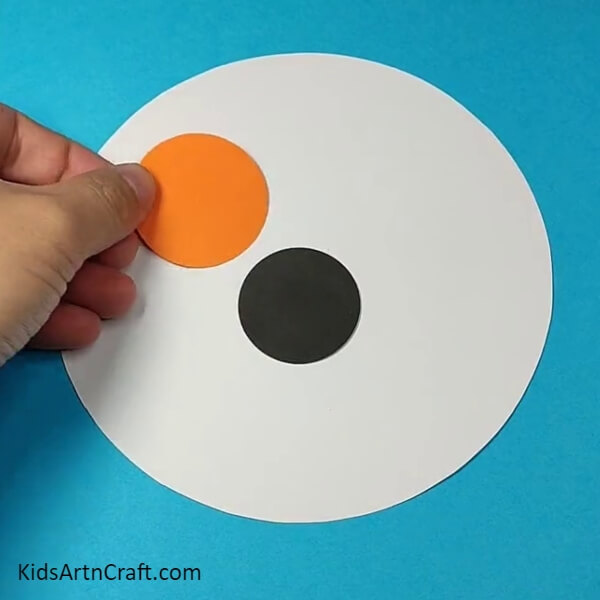Take an orange craft paper circle for the eye patch- A Simple Paper Dog Face Tutorial for Little Ones