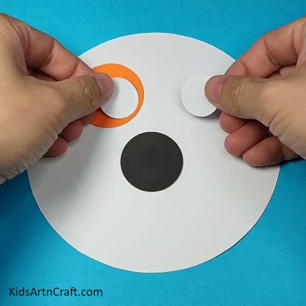 Stick two white circles for the eyes- Explaining How to Make a Dog Face Out of Paper to Kids