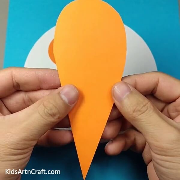 Make a heart shape cut out from Orange craft paper- A Guide to Crafting a Dog Face Out of Paper for Children