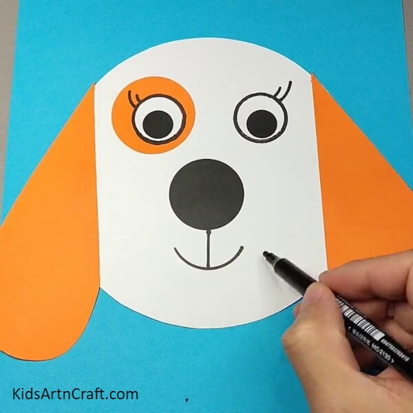 Drawing the eyelashes and the mouth of the dog- Crafting a Dog Face Mask from Paper - A Tutorial for Kids