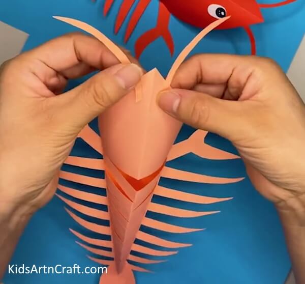 Pasting the Antennas- Instructions for Achieving a Fun Lobster Craft Out of Paper for Kids 