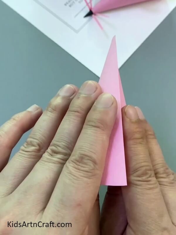 Folding paper to make cone- A paper mouse finger puppet is an easy project for novices to attempt.