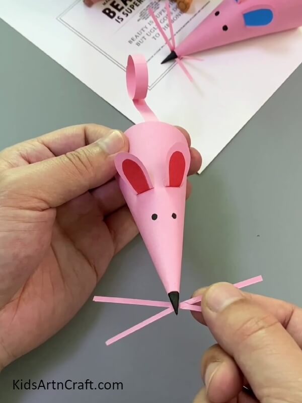 Making the nose hairs of the mouse- A paper mouse finger puppet craft tutorial is provided for starters.
