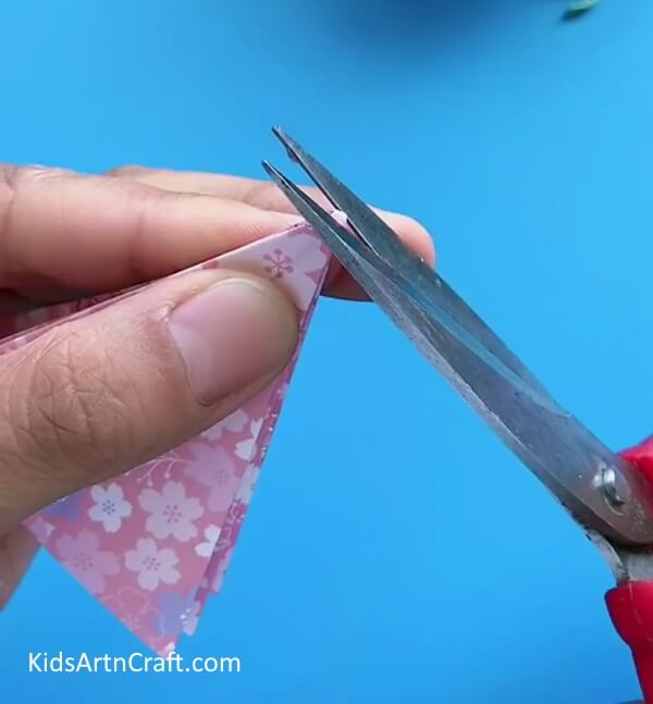 Cutting The Top Part Of The Umbrella With Scissors-How To Craft A Paper Umbrella - A Guide For Children