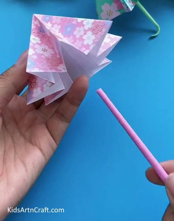 Inserting a Straw From Below The Umbrella- Instructions on How to Make a Simple Paper Umbrella for Kids