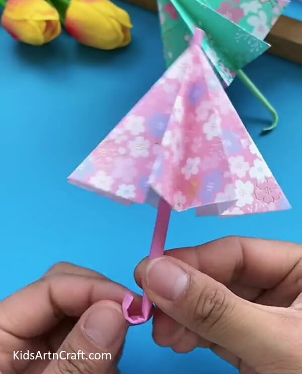 Folding The Bottom Part Of The Straw To Make a 'J'- Step-by-Step Guide to Constructing a Paper Umbrella for Children