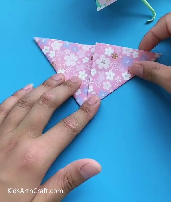 Fold The Printed Craft Paper Into a Triangle-A Step-By-Step Guide For Crafting A Paper Umbrella With Kids