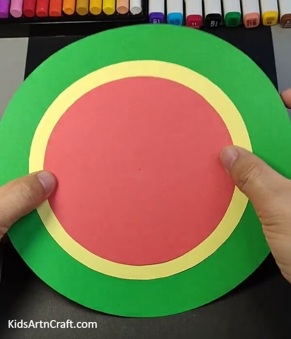 Pasting A Red Circle-A DIY Paper Watermelon Clock kids can make