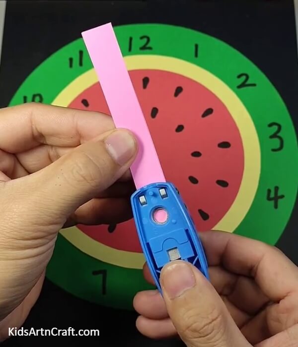 Punching A Hole-A Paper Watermelon Clock, is a fun project to do with kids